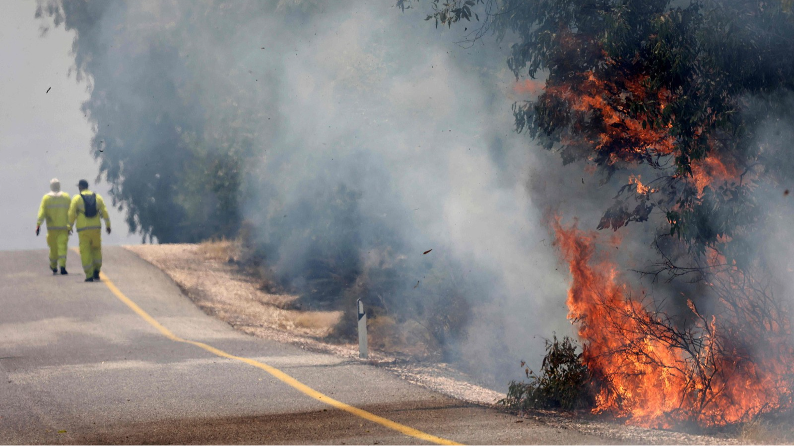 Israeli firefighters put out flames in a field after rockets launched from southern Lebanon landed on Banias area in the Israel-annexed Golan Heights, June 9, 2024. /CFP