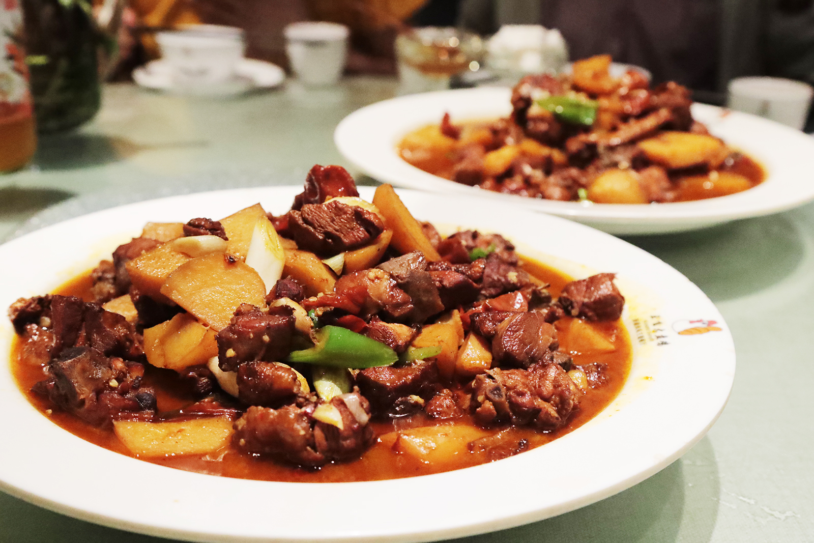 Plates of big plate chicken are served at a restaurant in Xinjiang. /CGTN