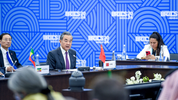 Chinese Foreign Minister Wang Yi (C), also a member of the Political Bureau of the CPC Central Committee, addresses the 