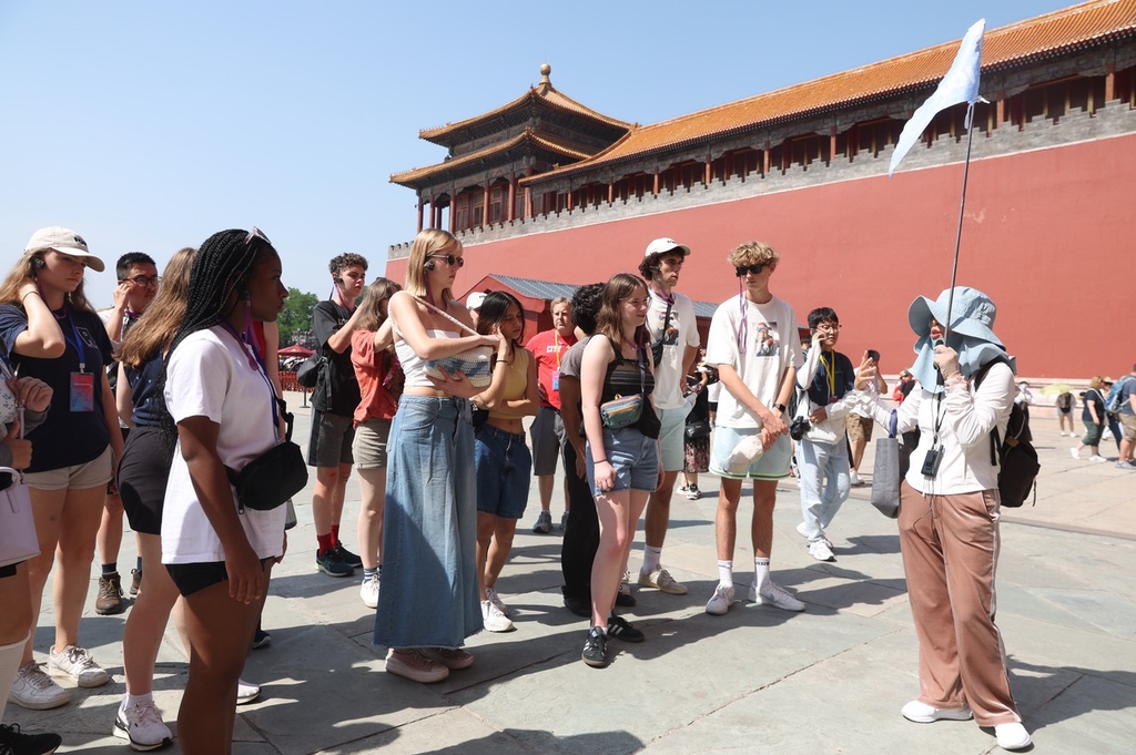 A photo taken on June 11, 2024 shows students and teachers from the U.S. state of Iowa listening to a tour guide at the Palace Museum in Beijing, China.