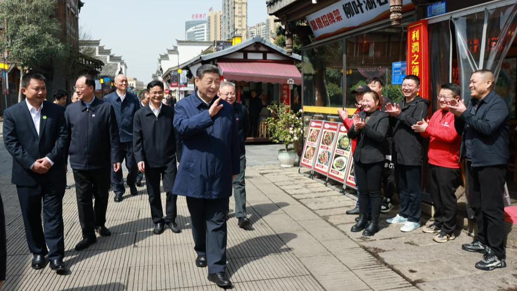 Chinese President Xi Jinping, also general secretary of the Communist Party of China Central Committee and chairman of the Central Military Commission, waves to people while visiting a cultural street in Changde, central China's Hunan Province, March 19, 2024. /Xinhua