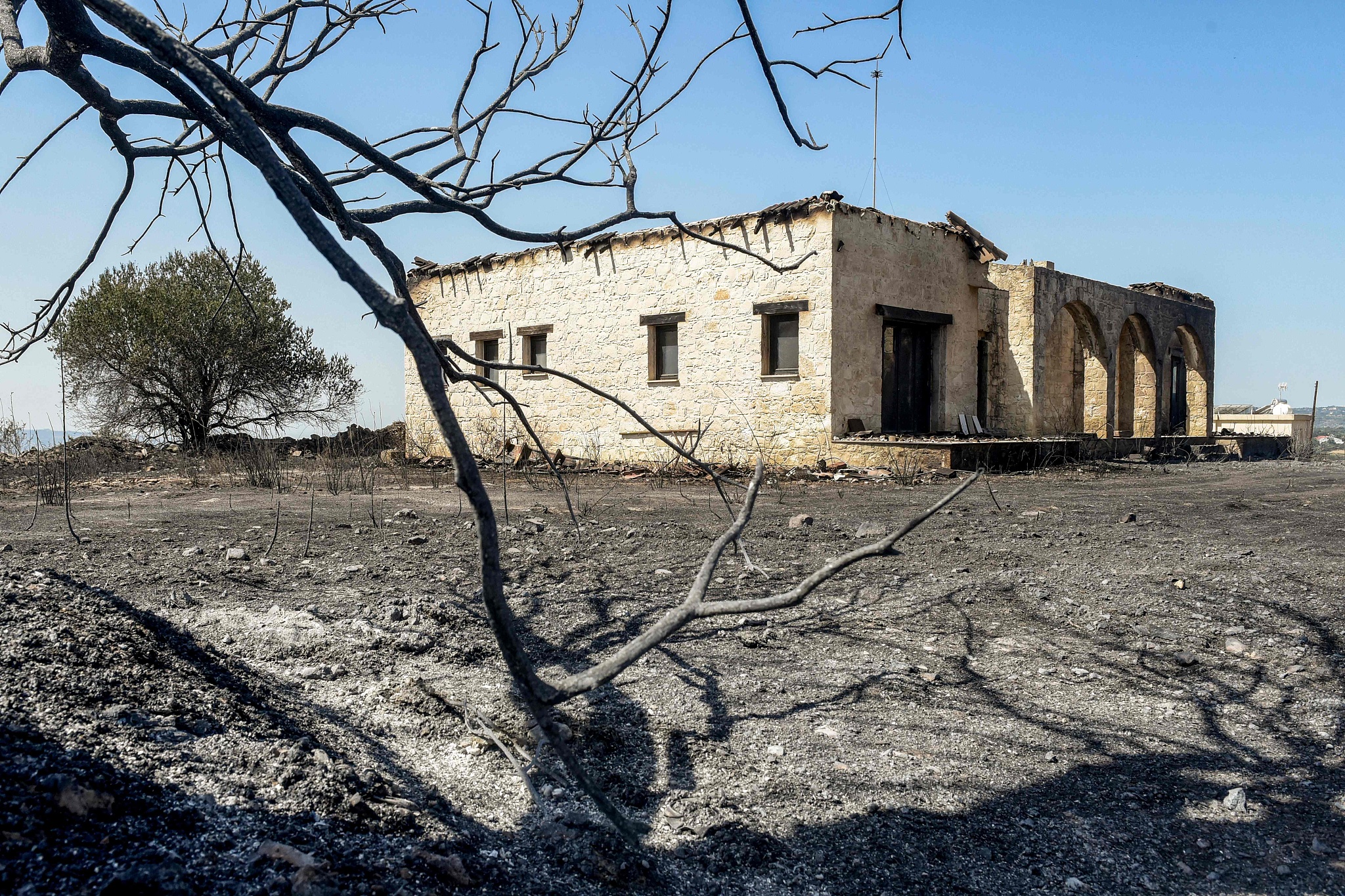 What is left after a house was burnt by a wildfire fueled by strong winds during a heat wave in the Psathi Village of western Cyprus, June 12, 2024. /CFP