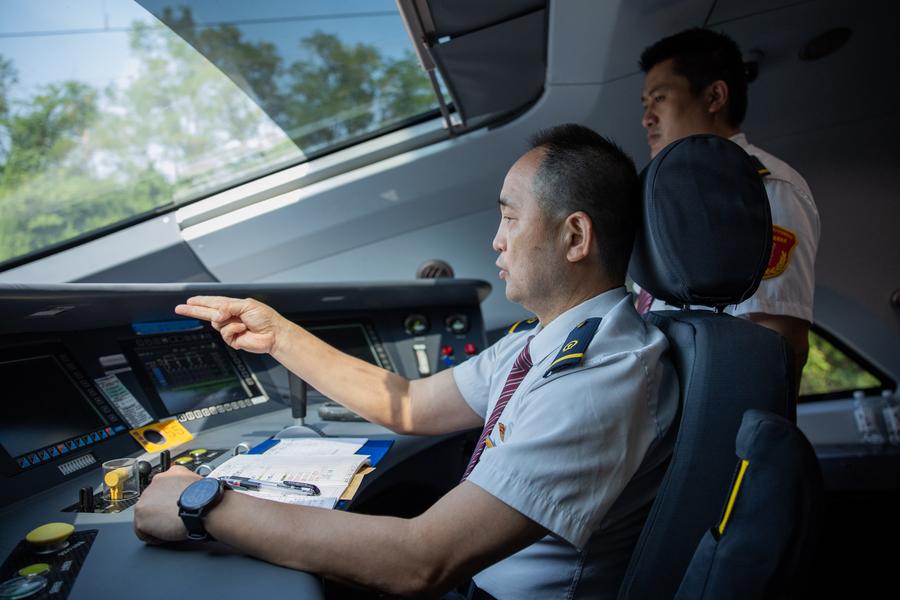 A driver checks the operational status of safety equipment onboard the G875 bullet train bound for Shenzhen on June 15, 2024. /Xinhua