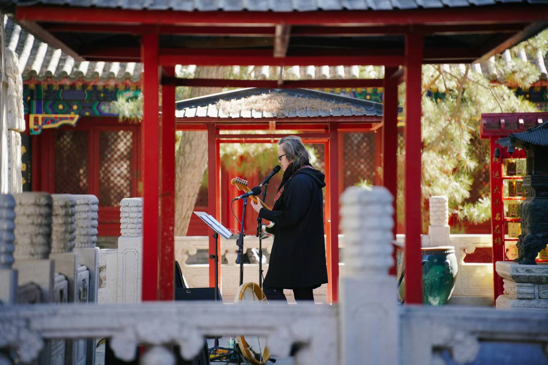 Song Song (Si Yang), a singer-songwriter, poet and photographer, plays at the Jietai Temple in Beijing, November 12, 2023. /Timeless Acoustics within the Ancient Walls