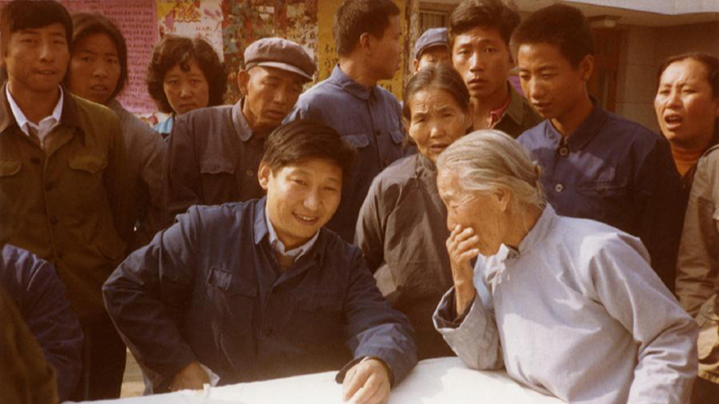 Xi Jinping (front, center) listens to locals in Zhengding, north China's Hebei Province, 1983. /China Media Group