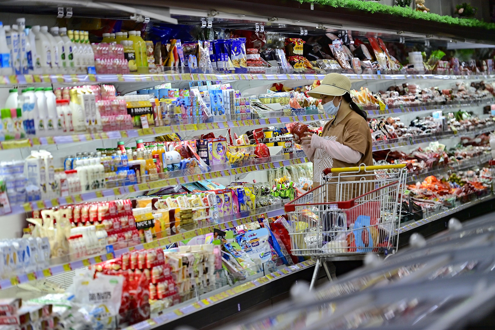 A consumer shops at a supermarket in Qingzhou city, China's Shandong province, June 12, 2024. /CFP