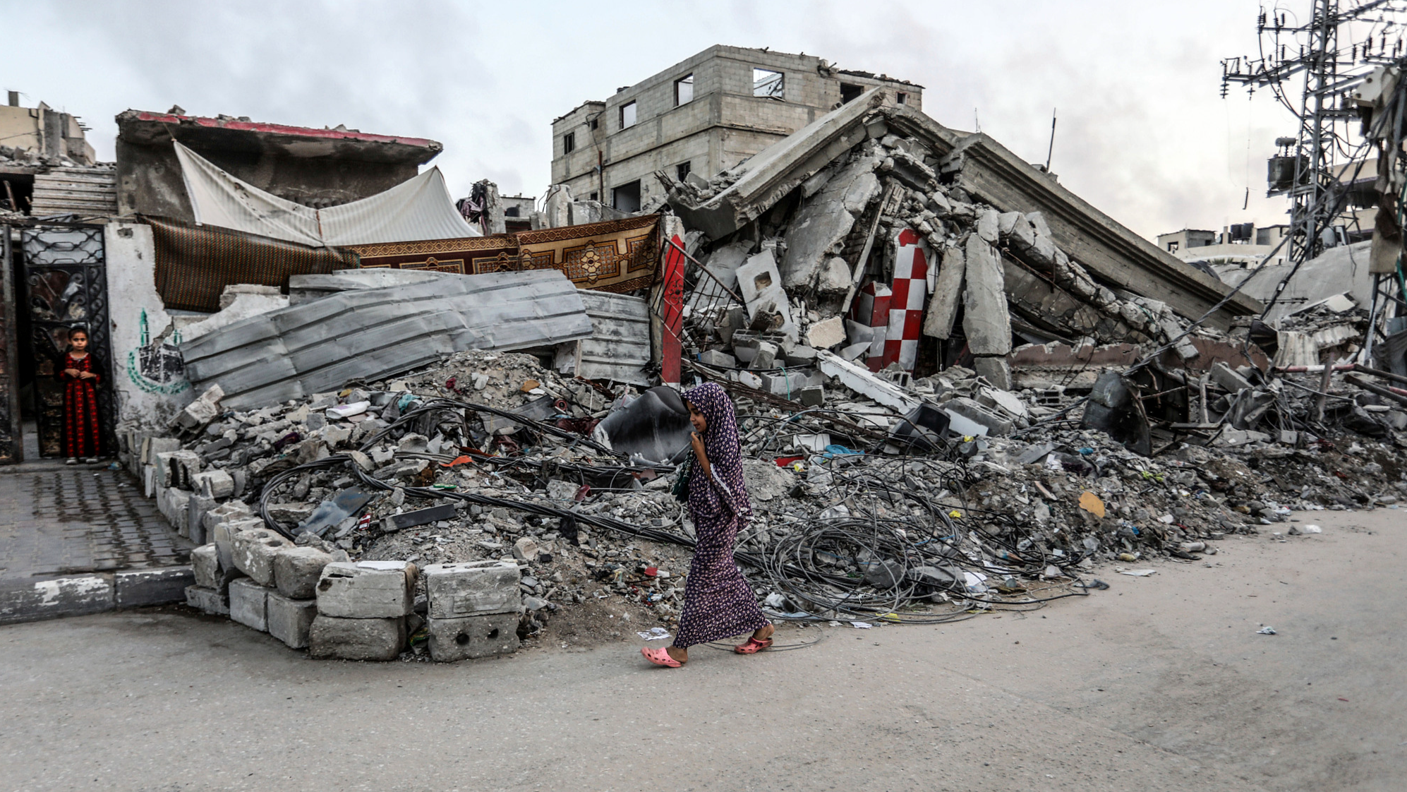 A Palestinian child walks in front of a destroyed home by Israeli warplanes in the city of Khan Younis in the southern Gaza Strip, June 16, 2024. /CFP