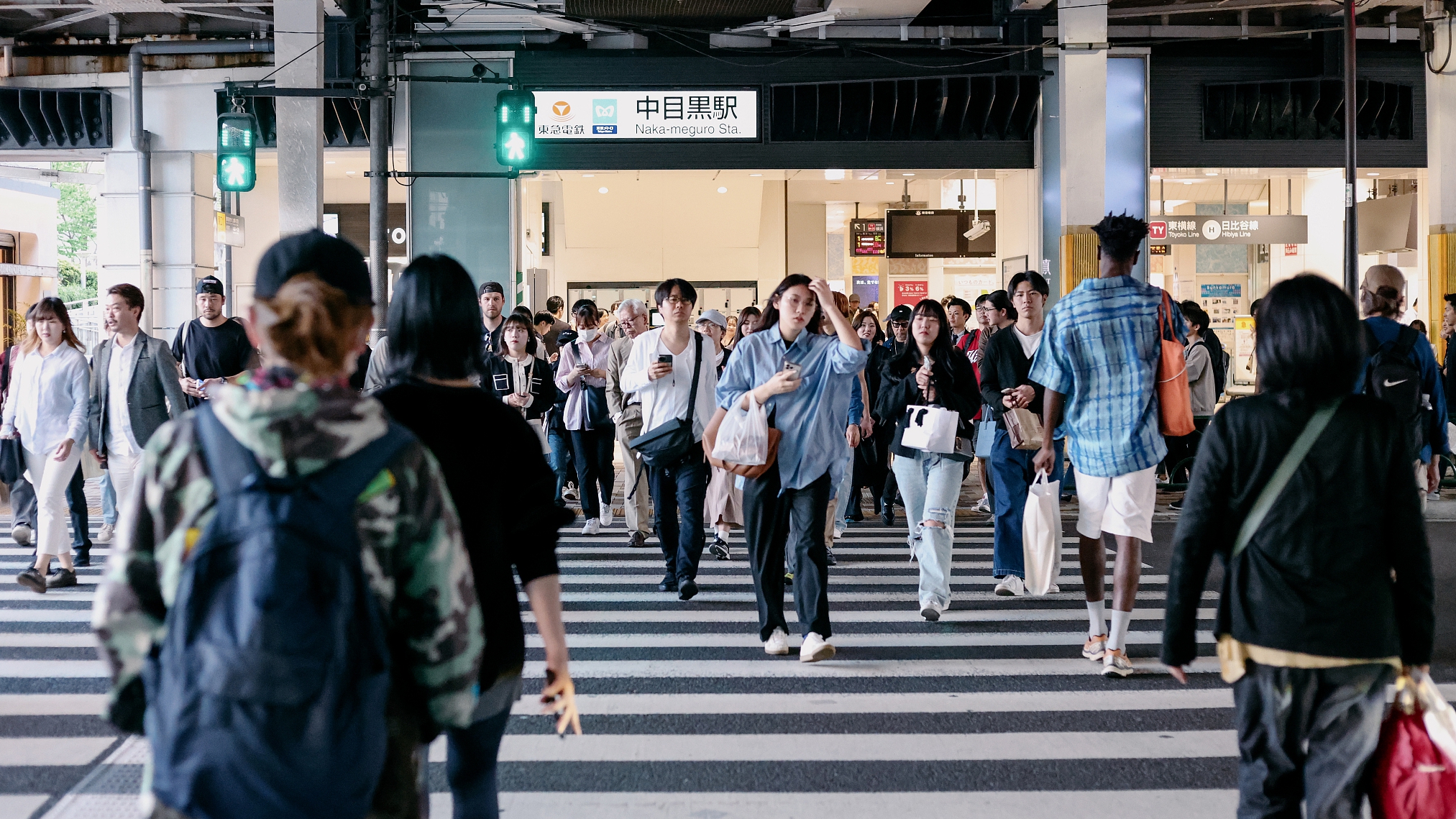 People walking in front of the Naka-meguro Station, Tokyo, Japan, April 14, 2024. /CFP 
