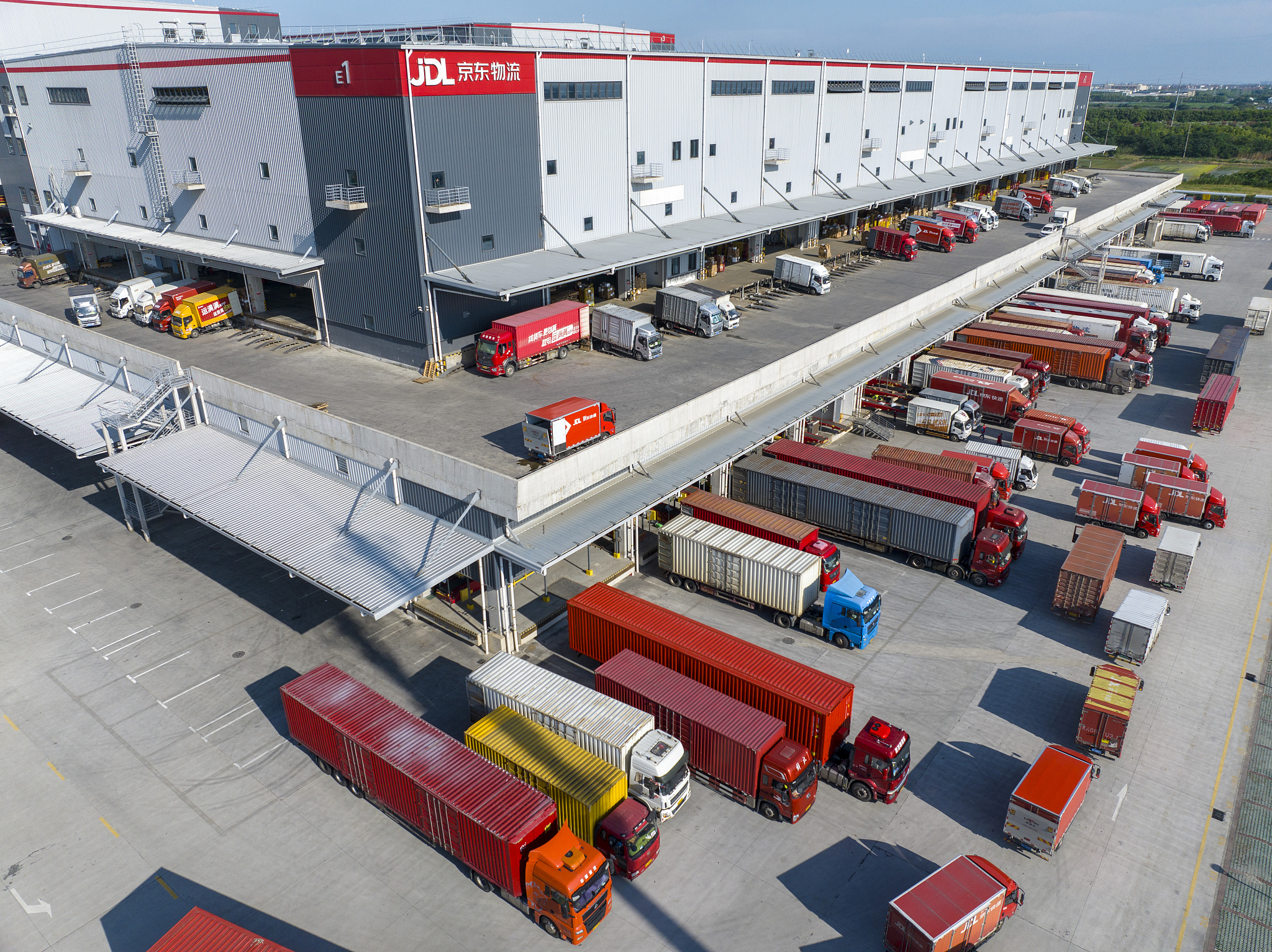 In a logistics park in Jiangsu Province, many express logistics trucks line up waiting to load and unload goods during China's mid-year online shopping festival known as the 