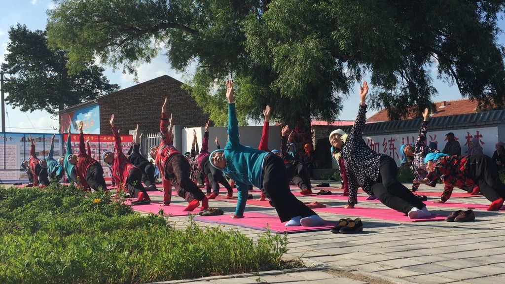 Elderly residents are seen in an undated photo gathering to practice yoga in Yugouliang Village, Hebei Province. /IC