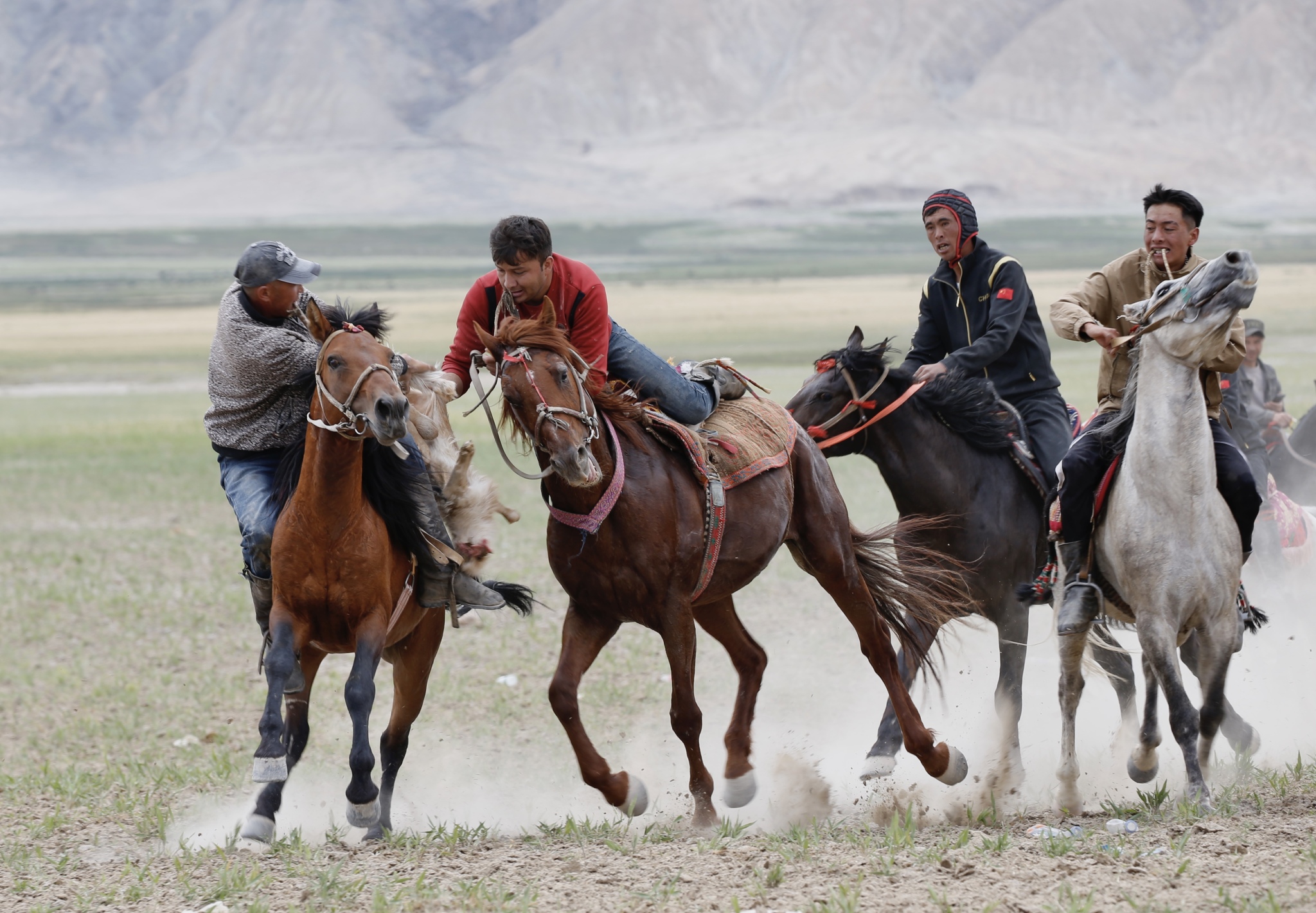 Riders are seen vying to seize a goat carcass during a Buzkashi competition held in Xinjiang on June 20, 2024. /CFP