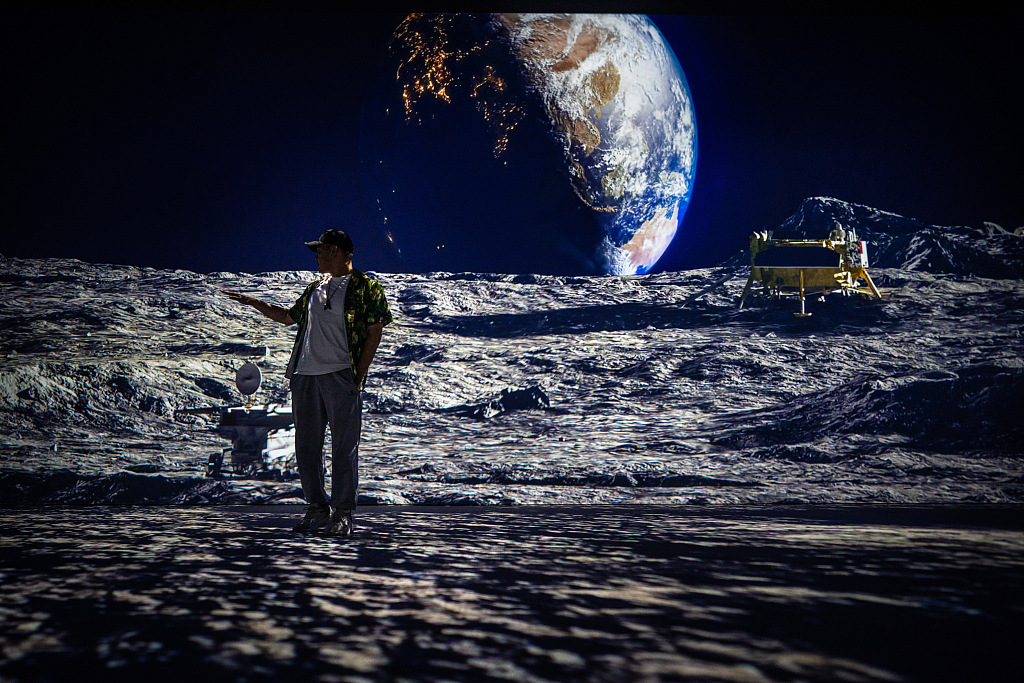 A visitor experiences an immersive view of the moon at the 