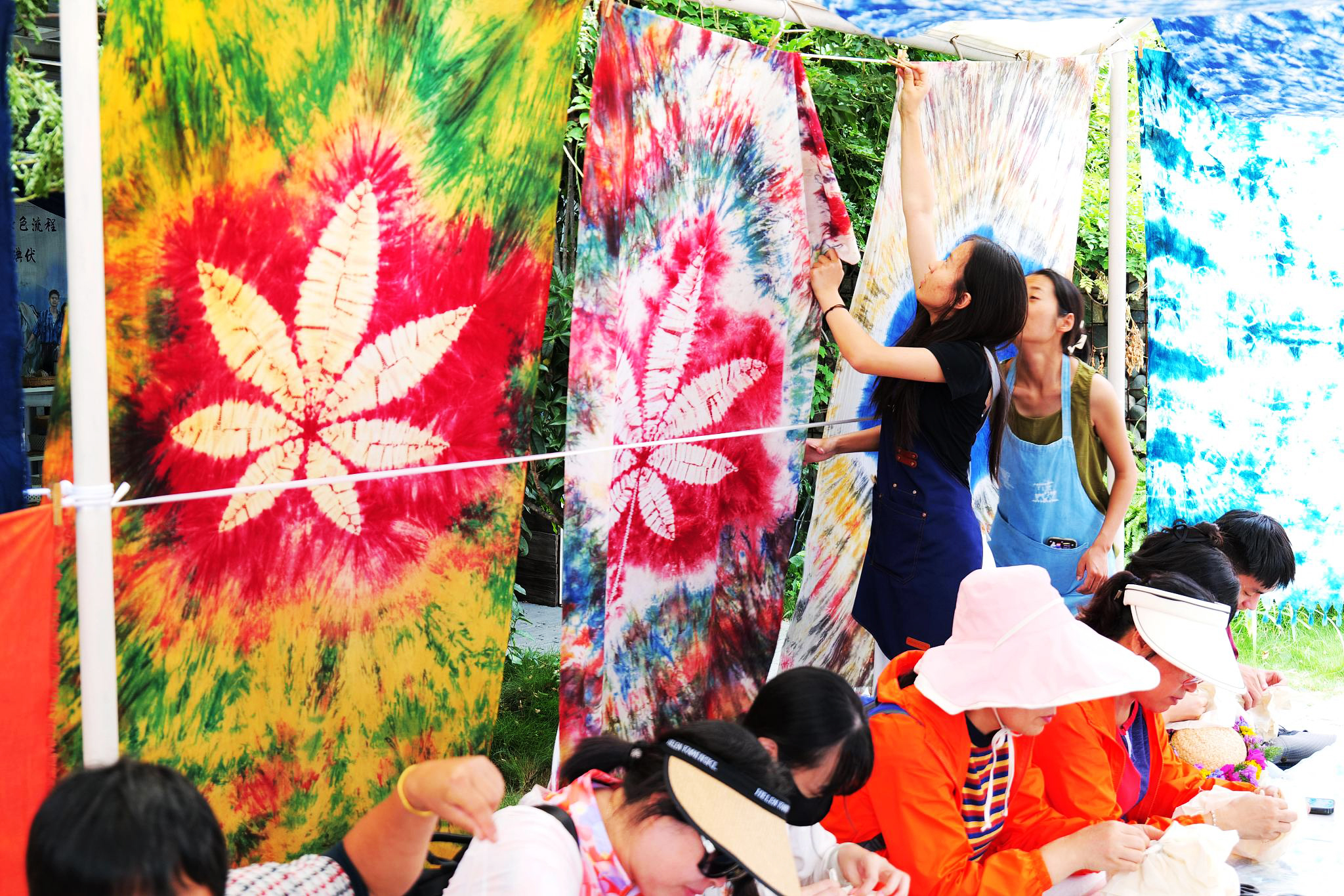 Tourists experience tie-dyeing in Dali, Yunnan Province on June 22, 2024. /CFP