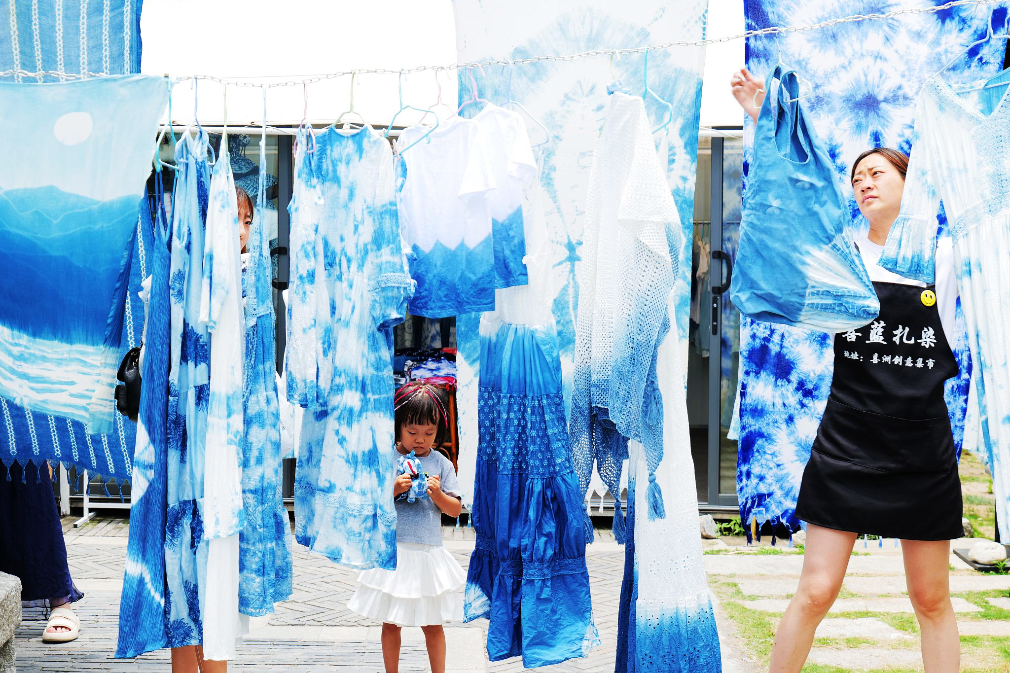 Tie-dye works are hung up in a courtyard in Dali, Yunnan Province on June 22, 2024. /CFP