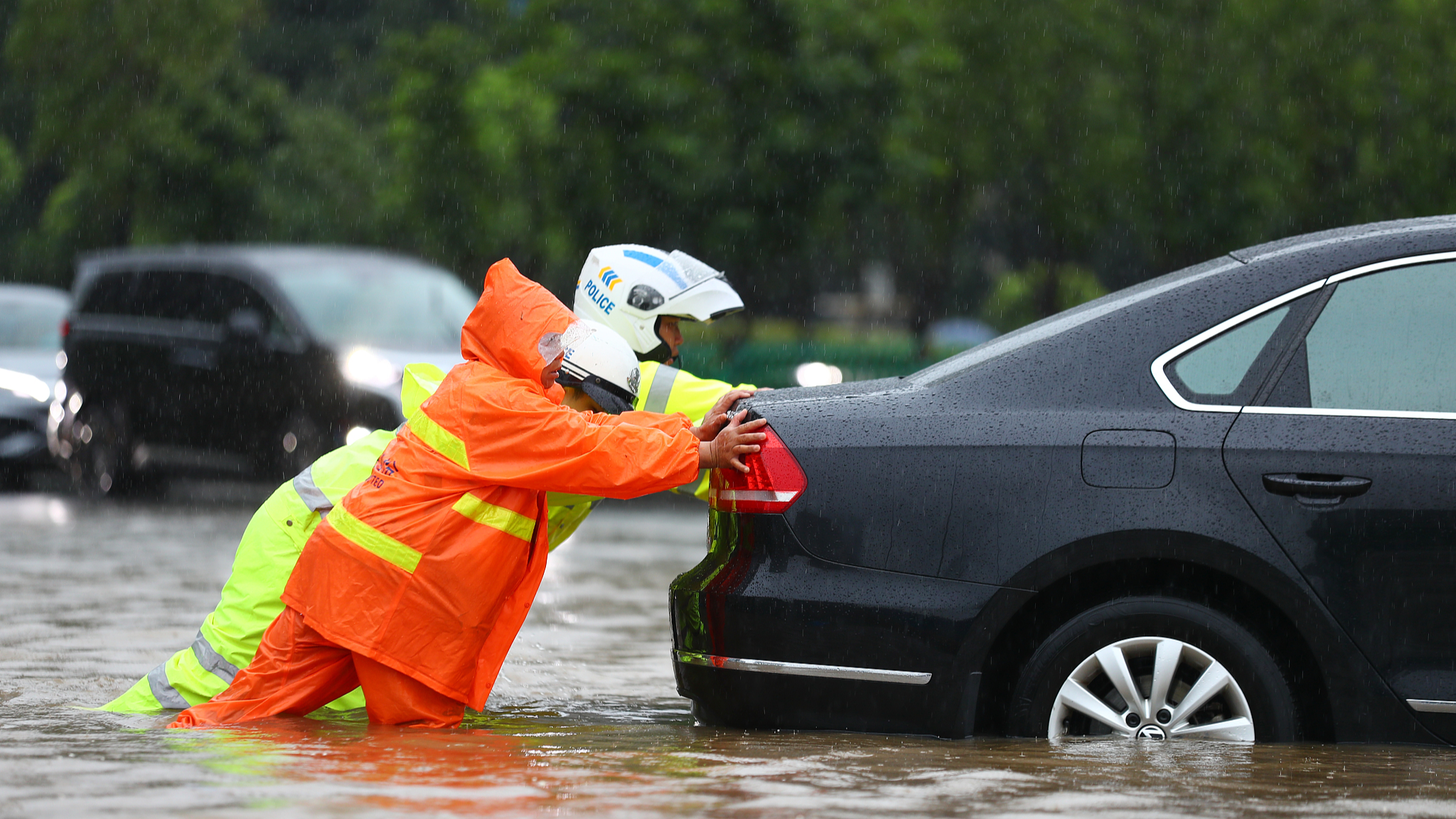 On June 24, 2024, in Nanchang City of east China's Jiangxi Province, police and a sanitation worker were pushing a car that had stalled in the water. That morning, the Nanchang Meteorological Observatory issued a red alert for heavy rain, with torrential rains occurring in many parts of the city. /CFP