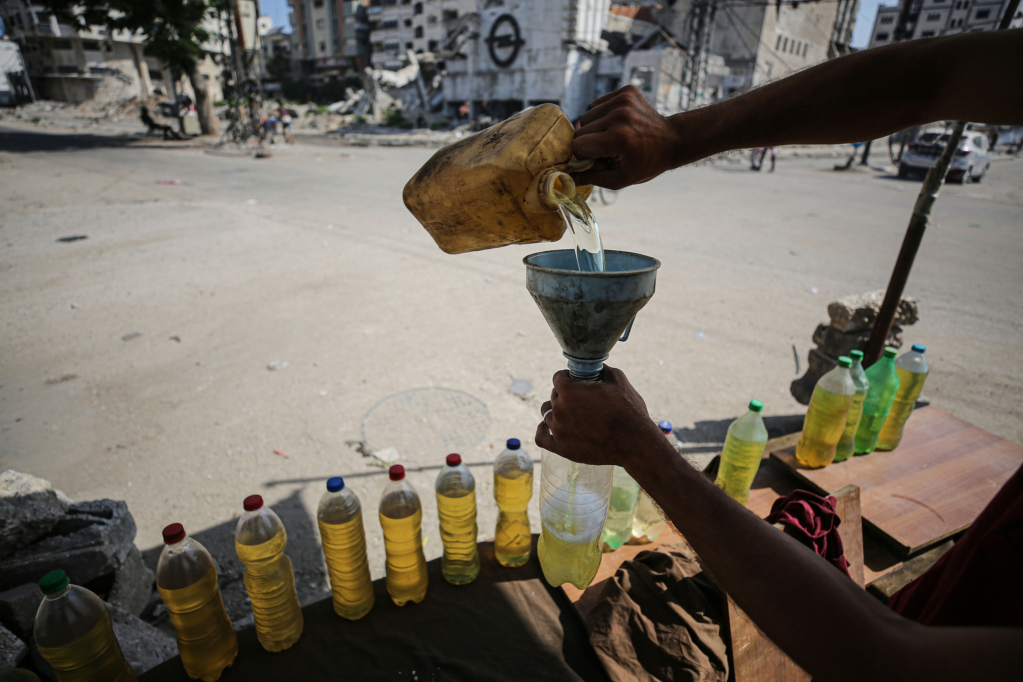 Palestinians add vegetable oil and diesel oil to their fuel tanks to start their vehicles due to the embargo imposed against fuels in Gaza, June 21, 2024. /CFP