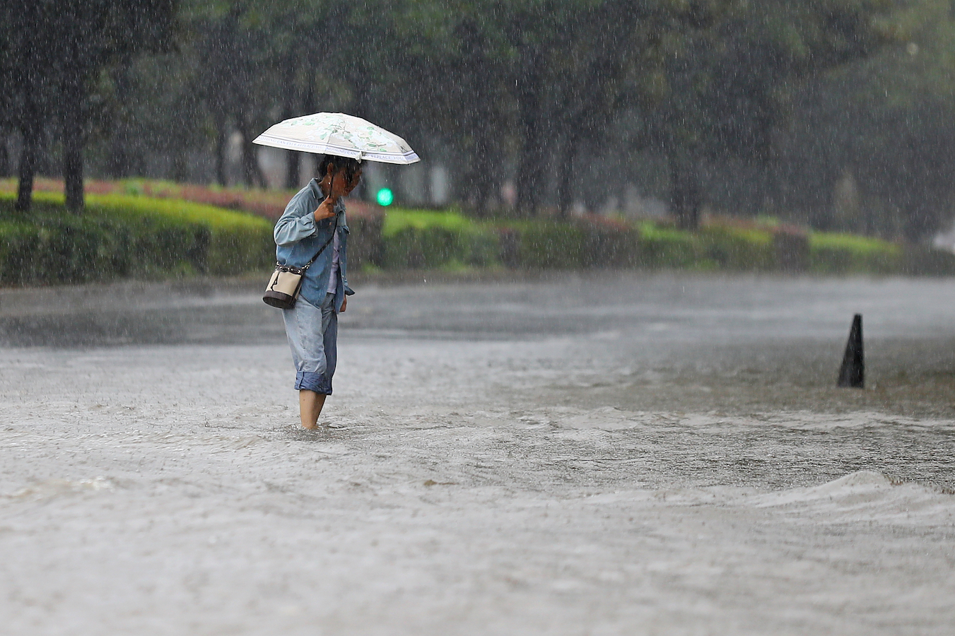 People wade through the rain in Nanchang City, Jiangxi Province, east China, June 24, 2024. /CFP