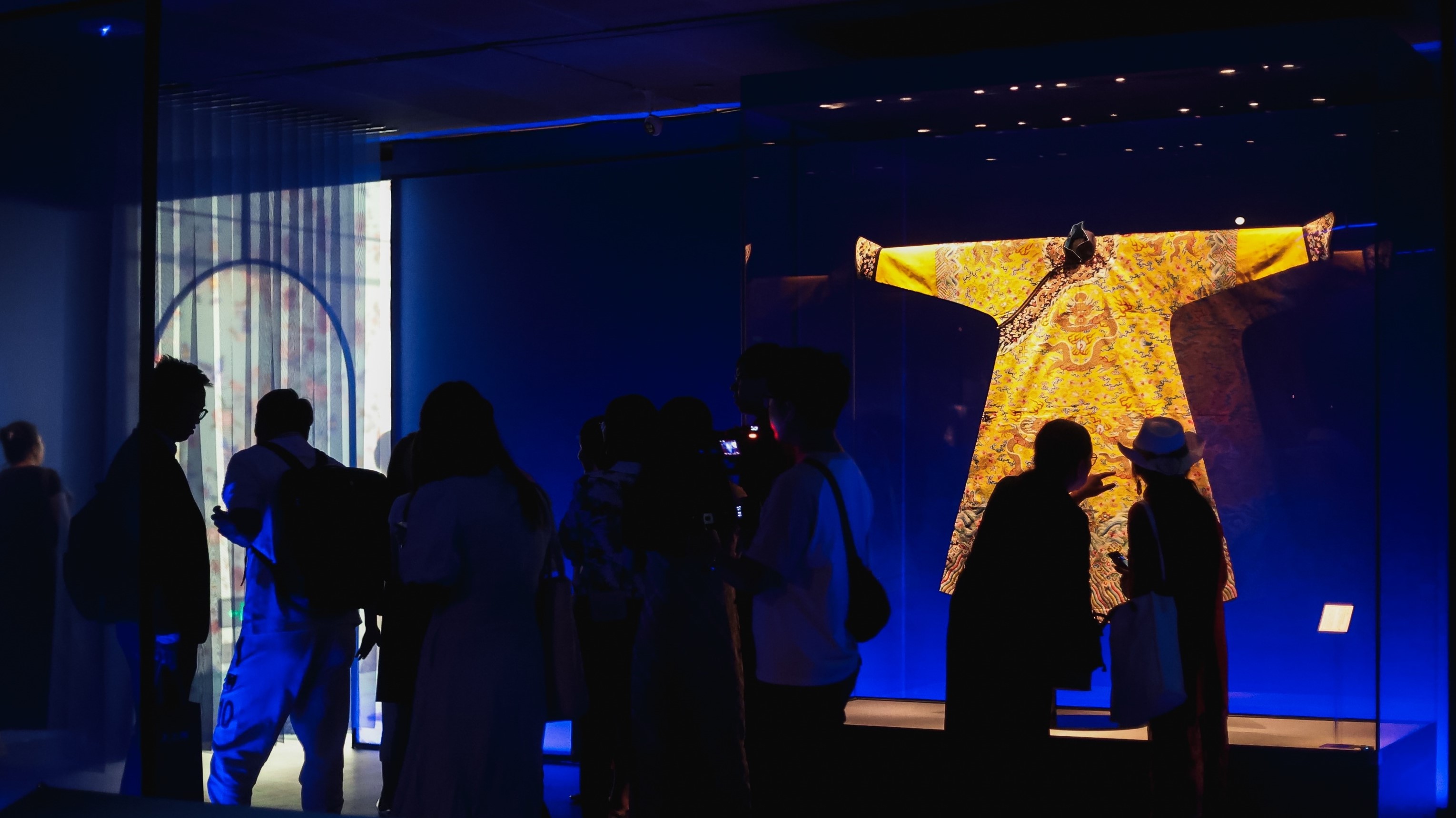 Visitors admire ancient garments at the 