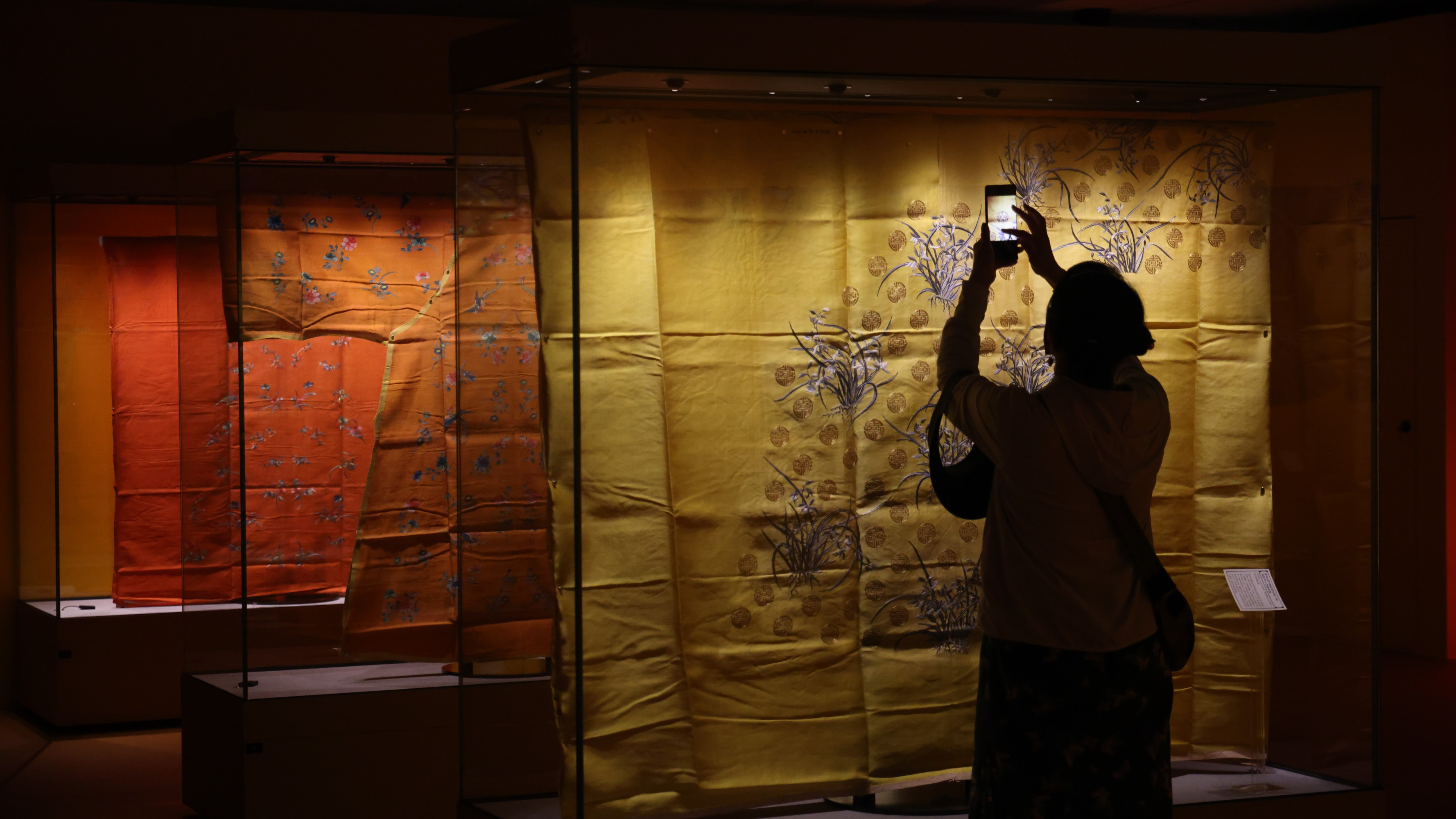 A visitor admires ancient garments at the 