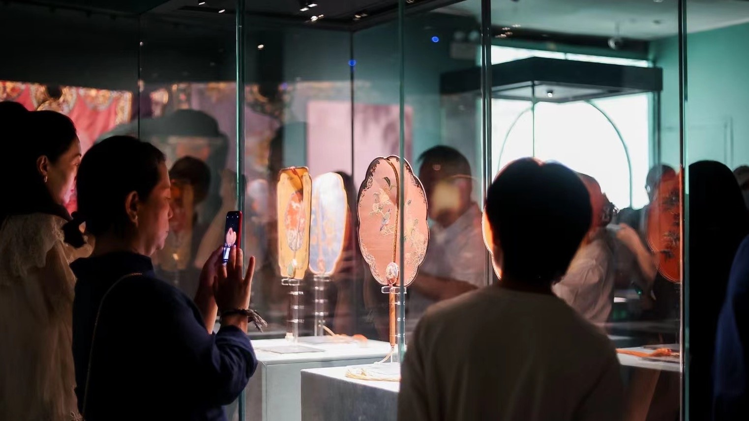 Visitors admire ancient garments at the 