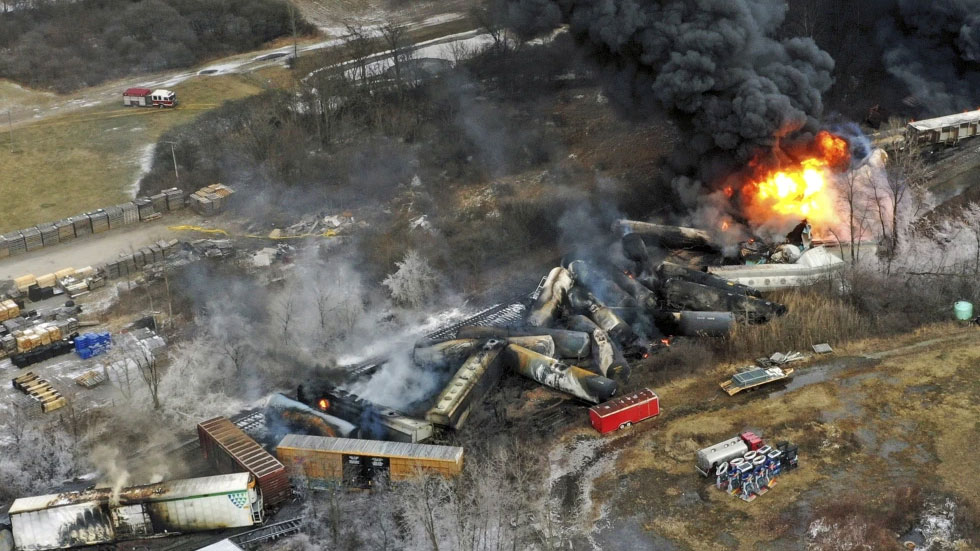 Debris from a Norfolk Southern freight train lie scattered and burning along the tracks, February 4, 2023. /AP