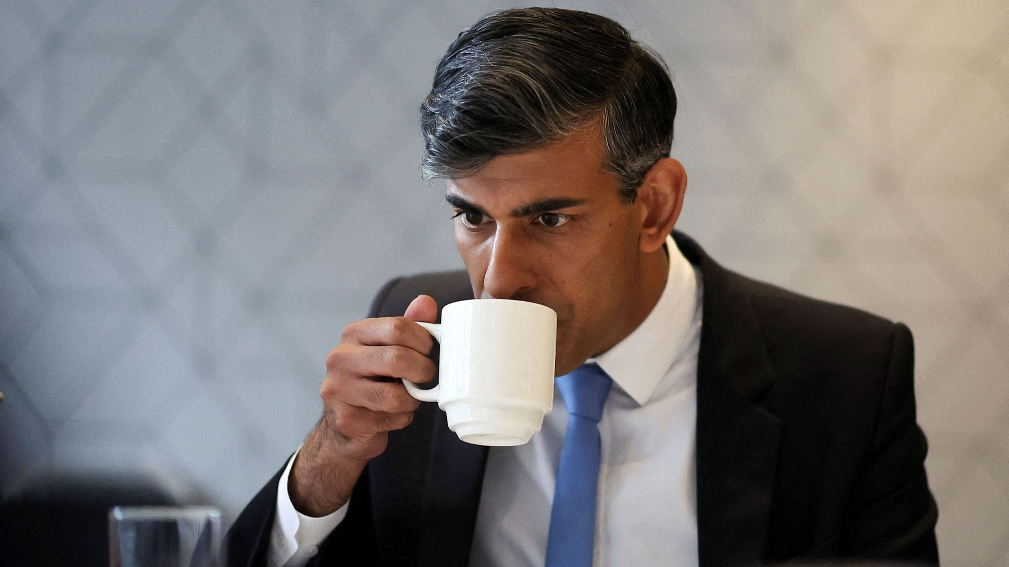 Britain's Prime Minister and leader of the ruling Conservative Party, Rishi Sunak, drinks from a mug during a general election campaign event at the Scottish Conservatives' manifesto launch in Edinburgh, Scotland, June 24, 2024. /CFP