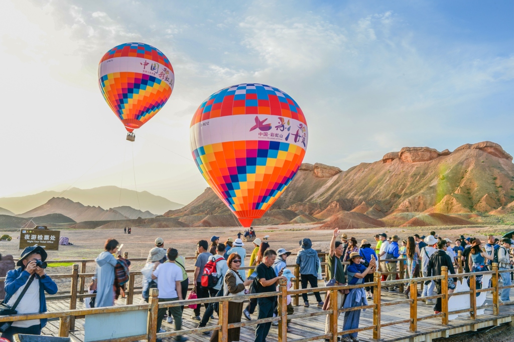 Hot air balloons take visitors for rides at the Colorful Danxia Scenic Spot in Zhangye, Gansu on June 25, 2024. /CFP