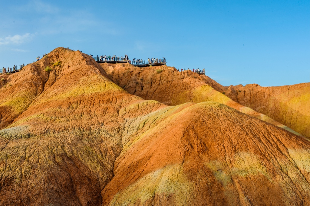 Visitors view the landscape of the Colorful Danxia Scenic Spot in Zhangye, Gansu on June 25, 2024. /CFP