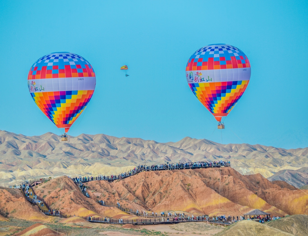 Hot air balloons float above the Colorful Danxia Scenic Spot in Zhangye, Gansu on June 25, 2024. /CFP