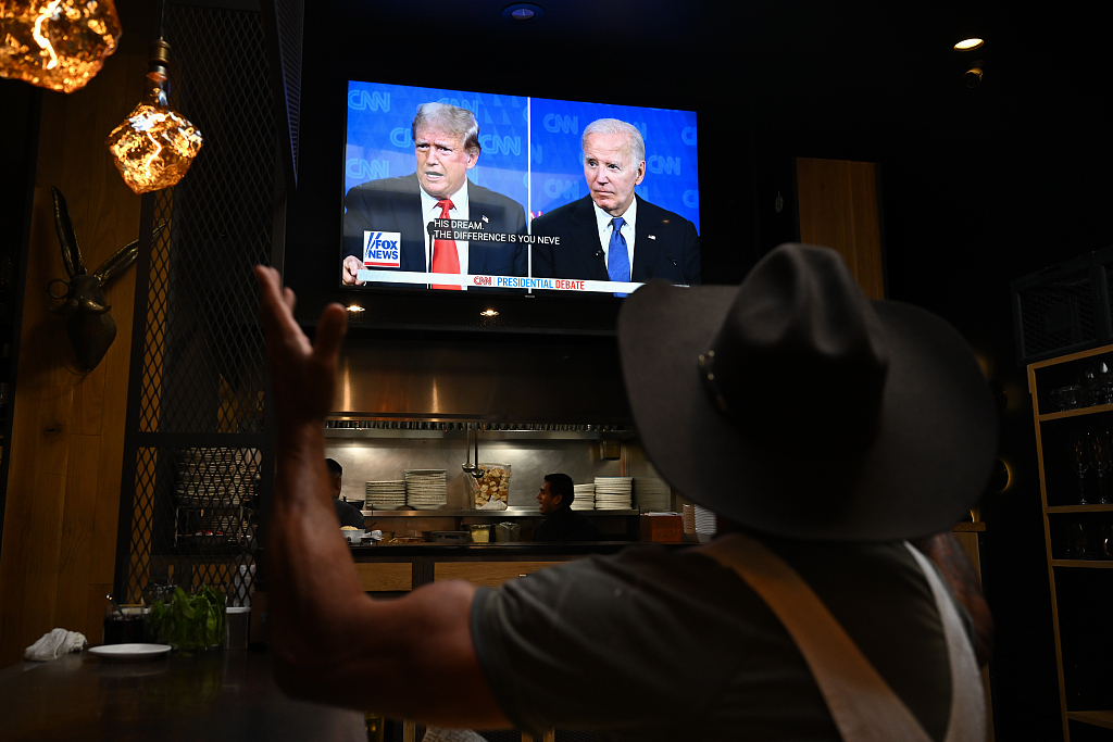 A man watches the 2024 Presidential Debate between Donald Trump and Joe Biden at a restaurant in San Carlos, California, United States, June 27, 2024. /CFP