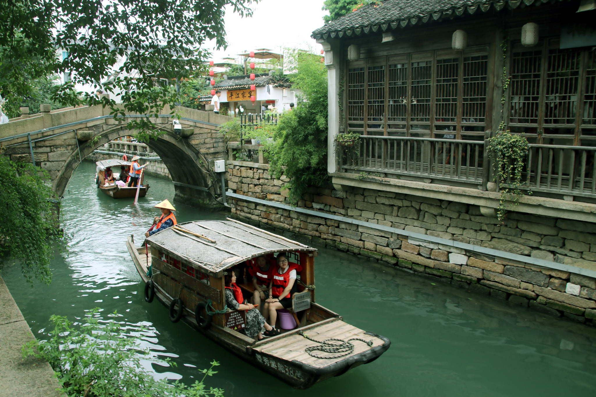 Tourists sail in a traditional hand-paddled boat along the ancient canals of Suzhou, Jiangsu Province, on June 27, 2024. /CFP