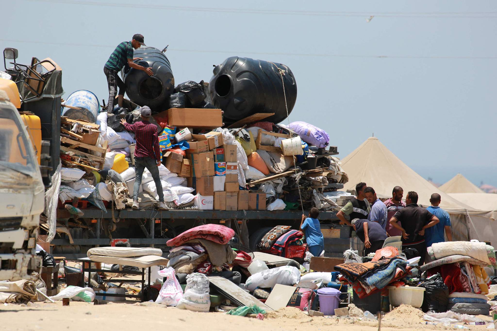 Displaced Palestinians load their belongings on a truck as they evacuate the Mawassi area in southwest Khan Yunis on the southern Gaza Strip on June 28, 2024. /CFP