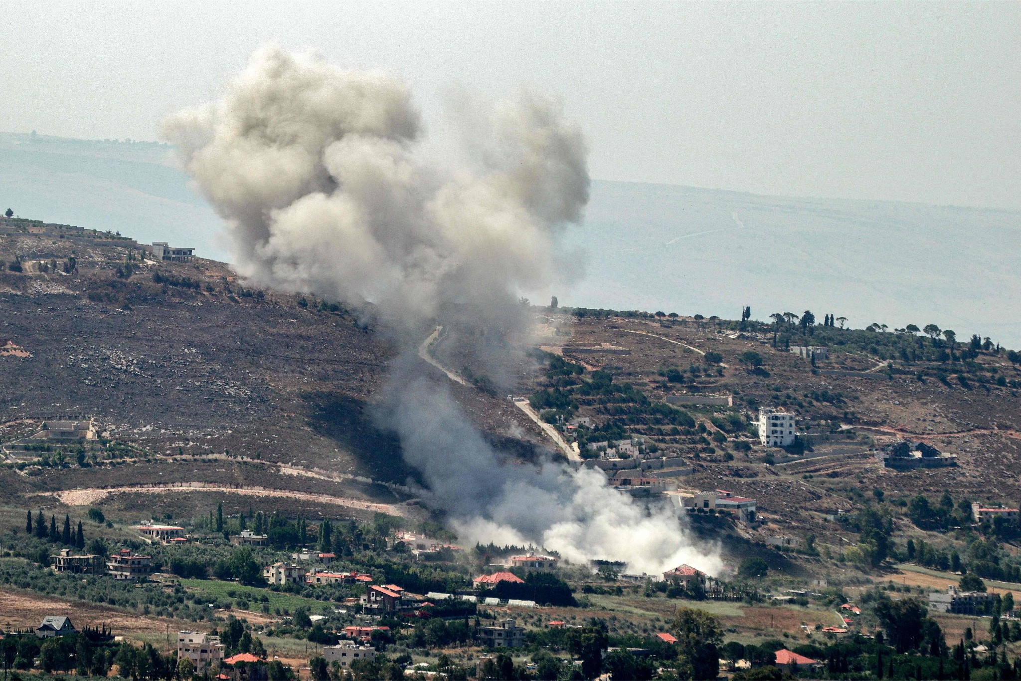 A smoke plume billows during Israeli bombardment on the village of Khiam in south Lebanon near the border with Israel, June 26, 2024. /CFP
