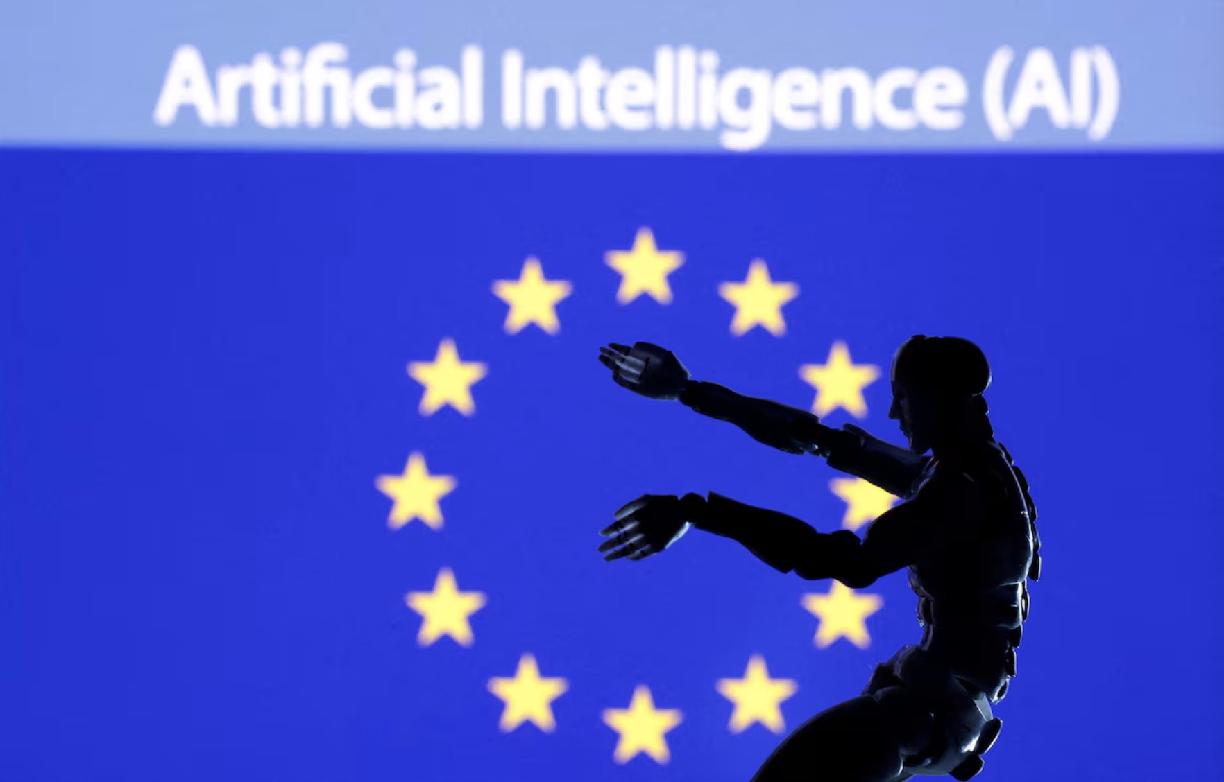 An illustration of AI artificial intelligence words, miniature of robot and EU flag. /Reuters