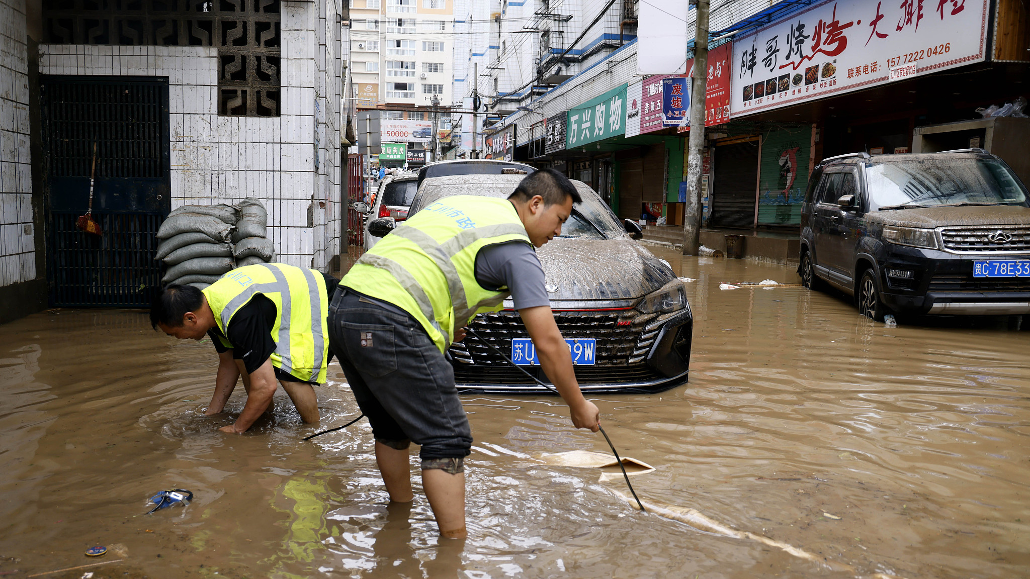 Workers carry out disaster relief efforts at urban waterlogging points in Huichuan District in Zunyi City, southwest China's Guizhou Province, June 29, 2024. /CFP