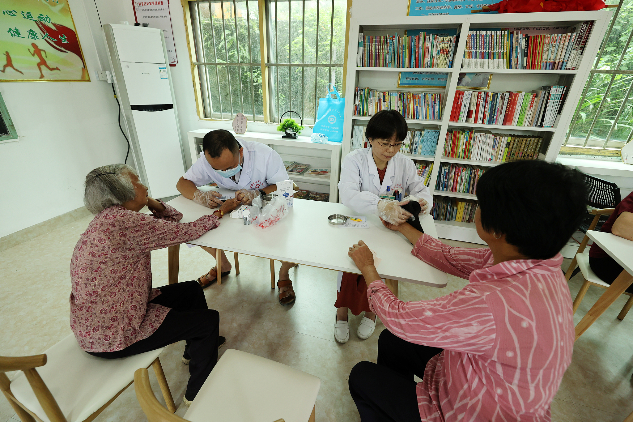 Medical staff conduct health checks on elderly residents in Gaofeng Village, a remote mountainous area in Quanzhou City, Fujian Province, southeast China, June 14, 2024. /CFP