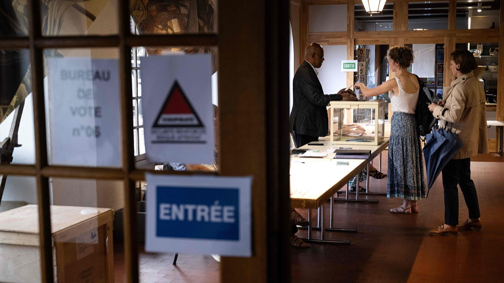 A voter casts her ballot at a polling station during the first round of parliamentary elections in Wissembourg, eastern France, June 30, 2024. /CFP