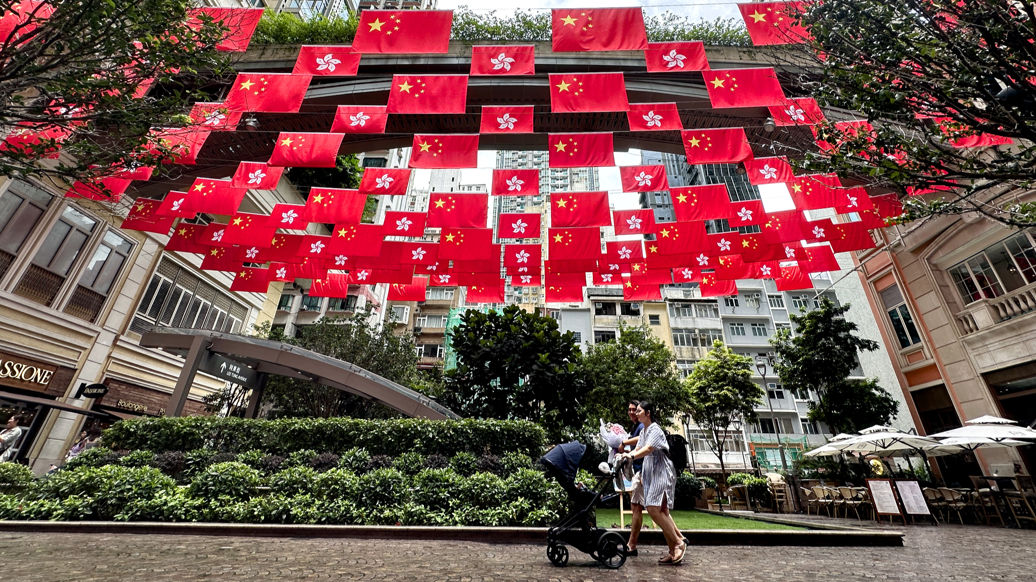 China's national flags and the flags of the Hong Kong Special Administrative Region are seen at a street in south China's Hong Kong, June 30, 2024. This year marks the 27th anniversary of Hong Kong's return to the motherland. /CFP