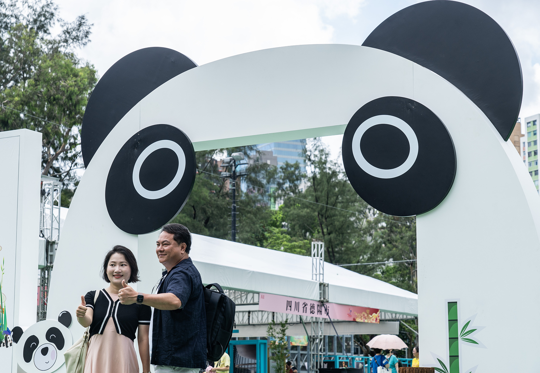Visitors take photos in front of a giant panda backdrop in Victoria Park, Hong Kong, China, July 1, 2024. /CFP