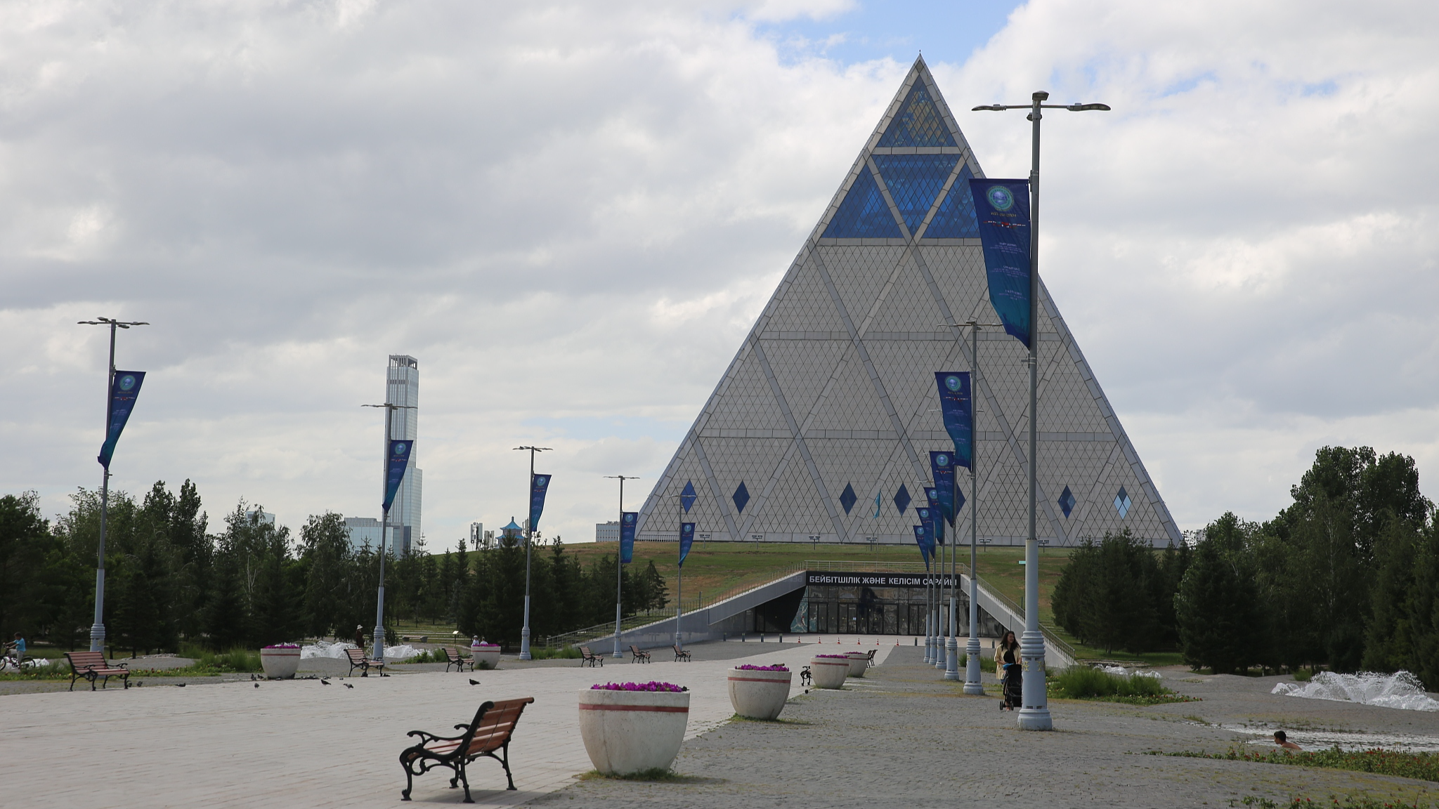 Welcome flags announcing the 24th Meeting of the Council of Heads of State of the Shanghai Cooperation Organization line the pathway to the entrance to the Palace of Peace and Reconciliation in Astana, Kazakhstan. /CFP
