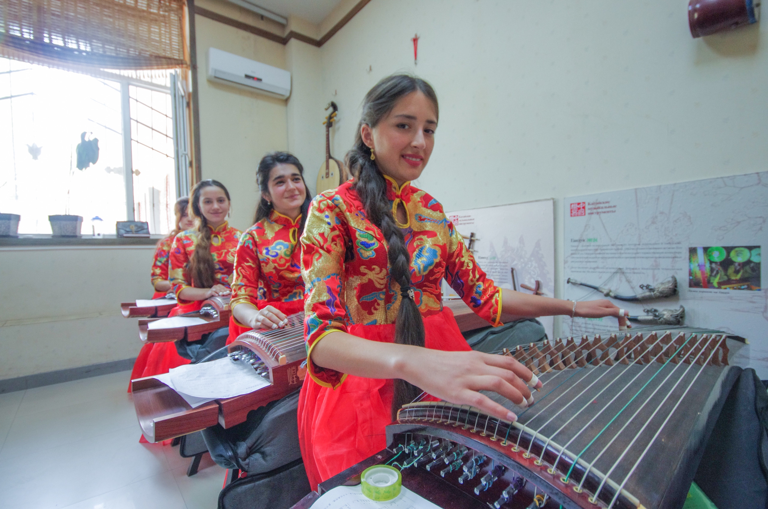 A file photo shows students from the Confucius Institute in Dushanbe, the capital of Tajikistan, performing the guzheng. The Confucius Institute at the Tajik National University is a non-profit educational institution. Through their programs, local people can learn about and experience Chinese culture, bolstering friendly relations between the two countries. /IC