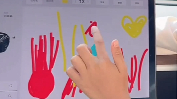 Molly uses Tesla's touchscreen to draw a picture. /Weibo