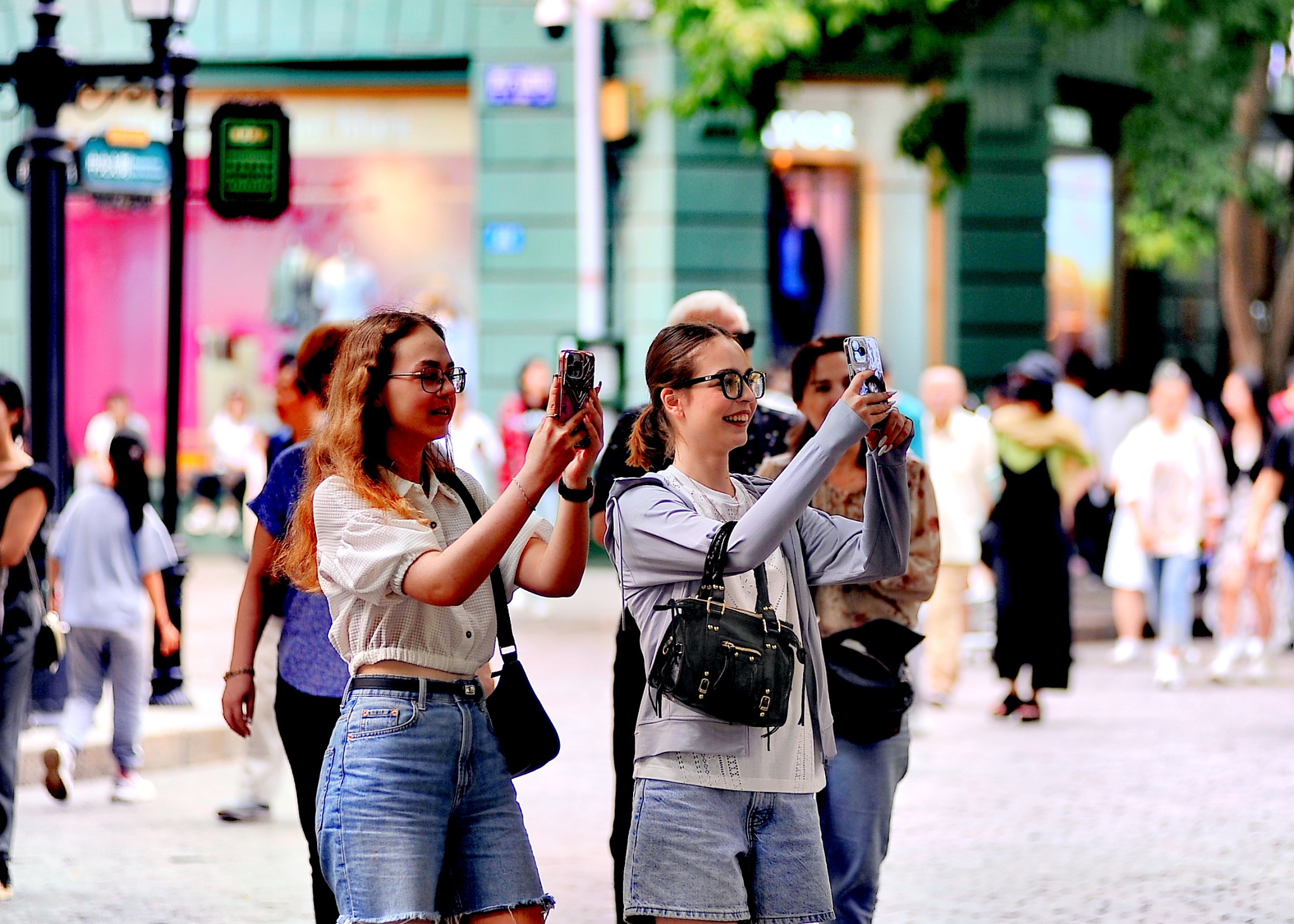 Tourists take photos at Central Street, or Zhongyang Street, in Harbin, 
the capital city of China's northernmost province of Heilongjiang, July 4, 2024. /CFP