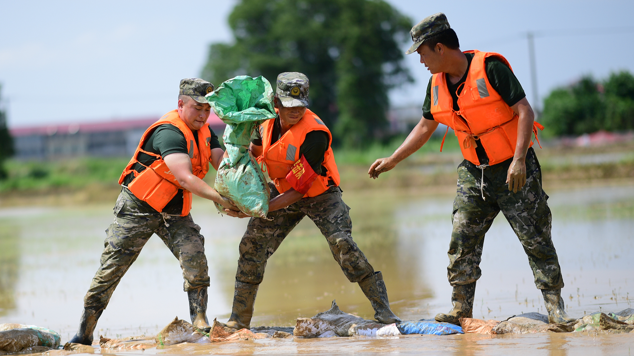 Police officers are fighting on the front lines of flood control and disaster relief in Jiujiang City, east China's Jiangxi Province. /CFP