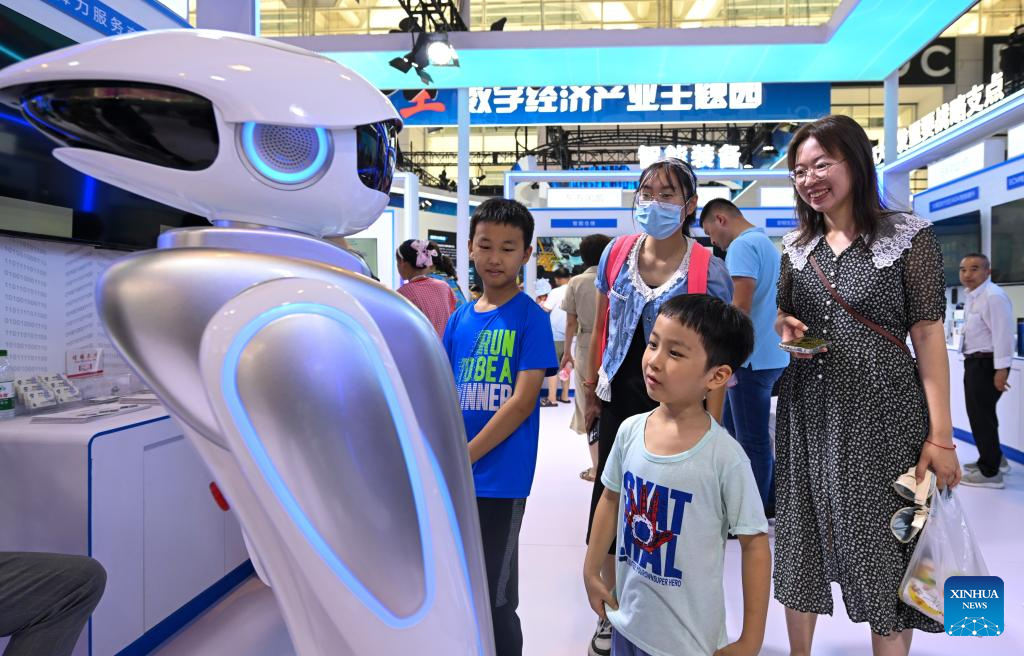 Visitors interact with a robot at the World Intelligence Expo 2024 in north China's Tianjin, June 22, 2024. /Xinhua