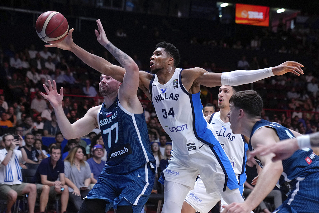 Giannis Antetokounmpo (#34) of Greece and Luka Doncic (#77) of Slovenia compete for the ball in the semifinals of one of the 2024 FIBA Men's Olympic Qualifying Tournaments semifinals in Piraeus, Greece, July 6, 2024. /CFP