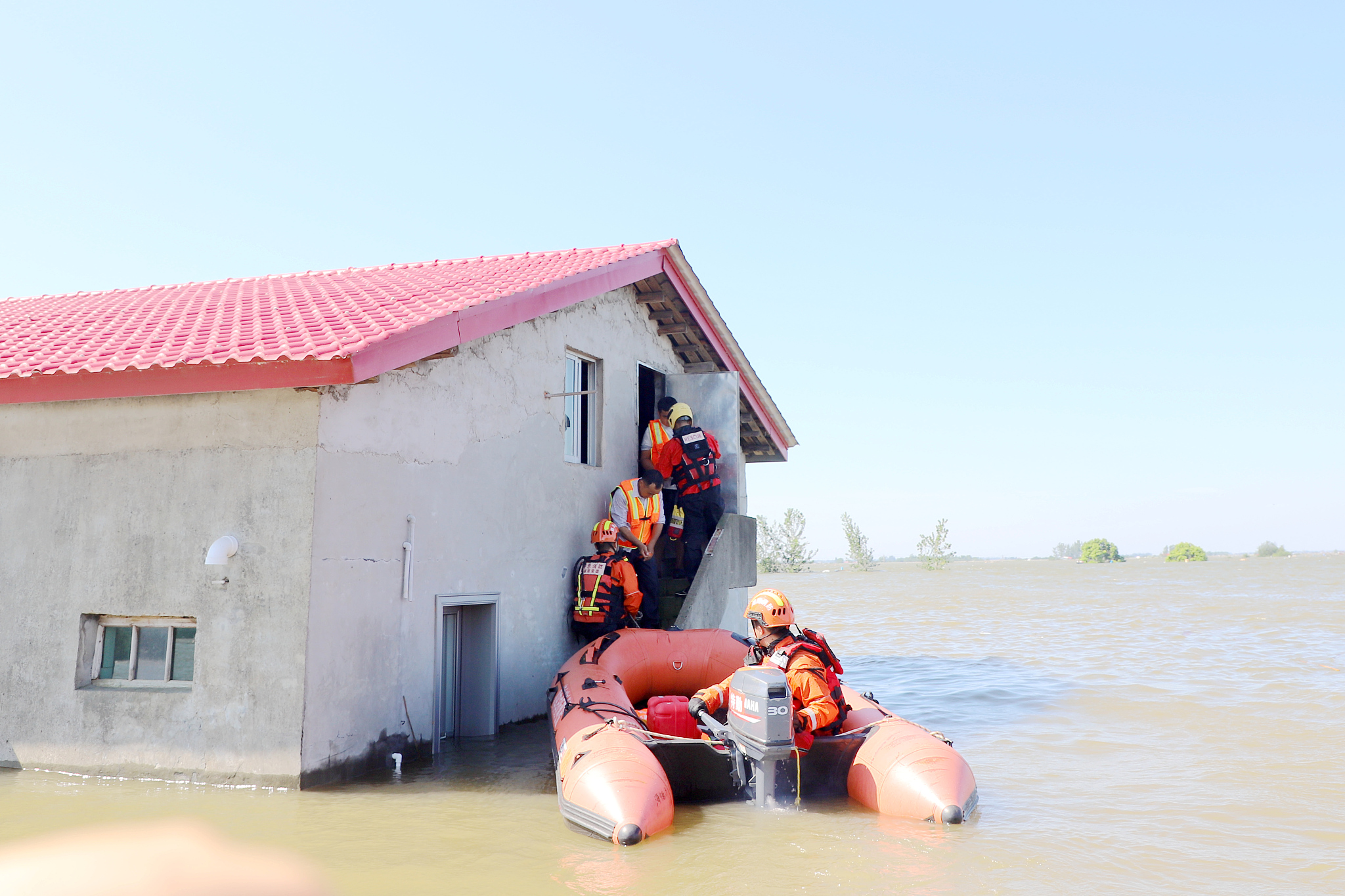 Firefighters evacuate people trapped by floods in Tuanbei Village, central China's Hunan Province, July 6, 2024. /CFP