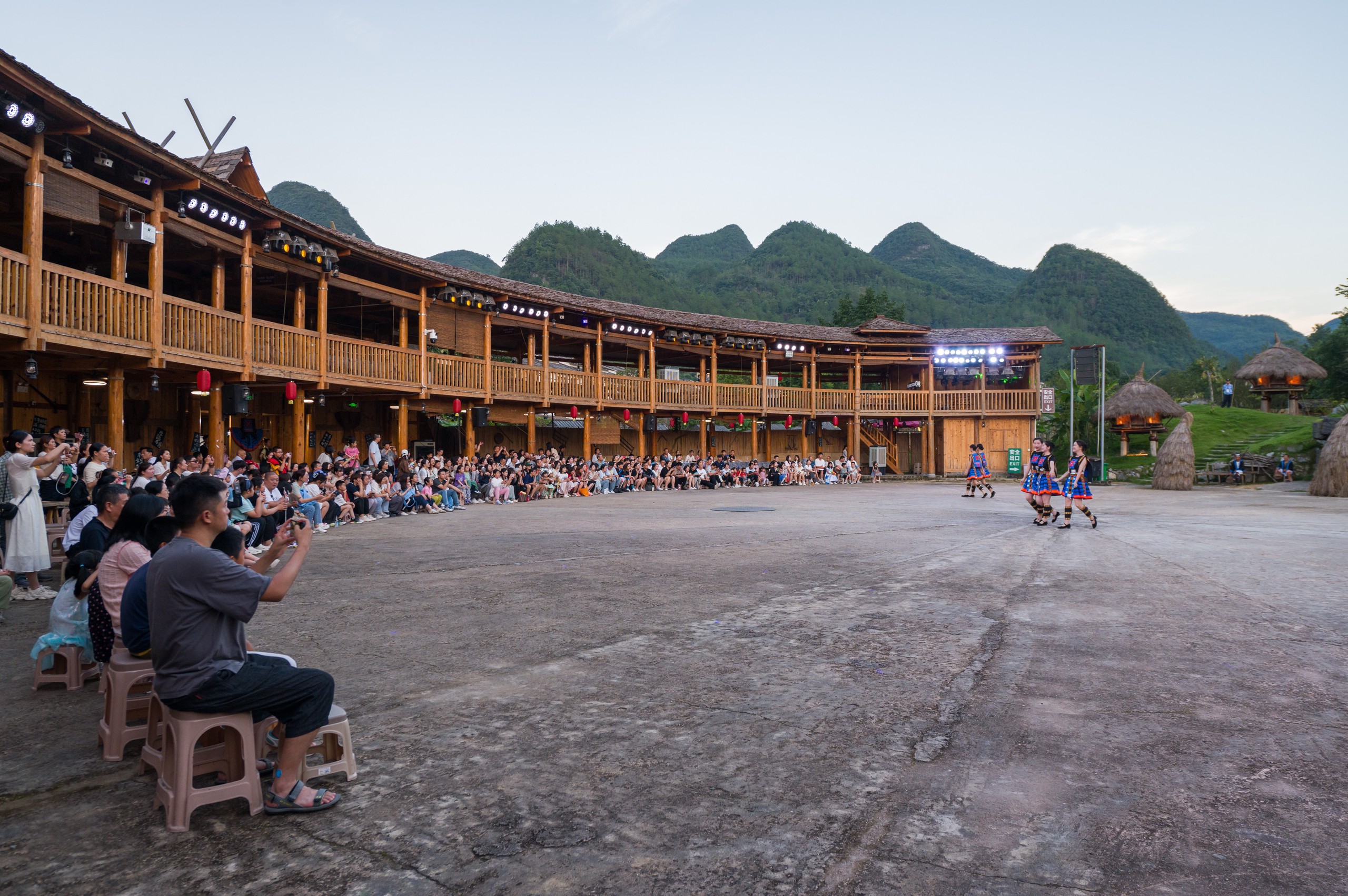 Tourists watch a performance of 