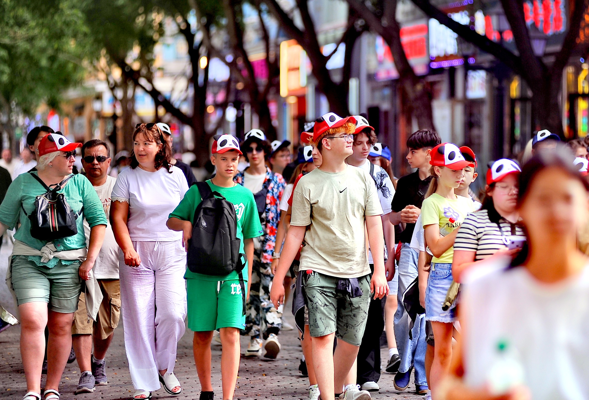 Foreign tourists walk along Central Street in Harbin City, capital of northeast China's Heilongjiang Province, July 4, 2024. /CFP