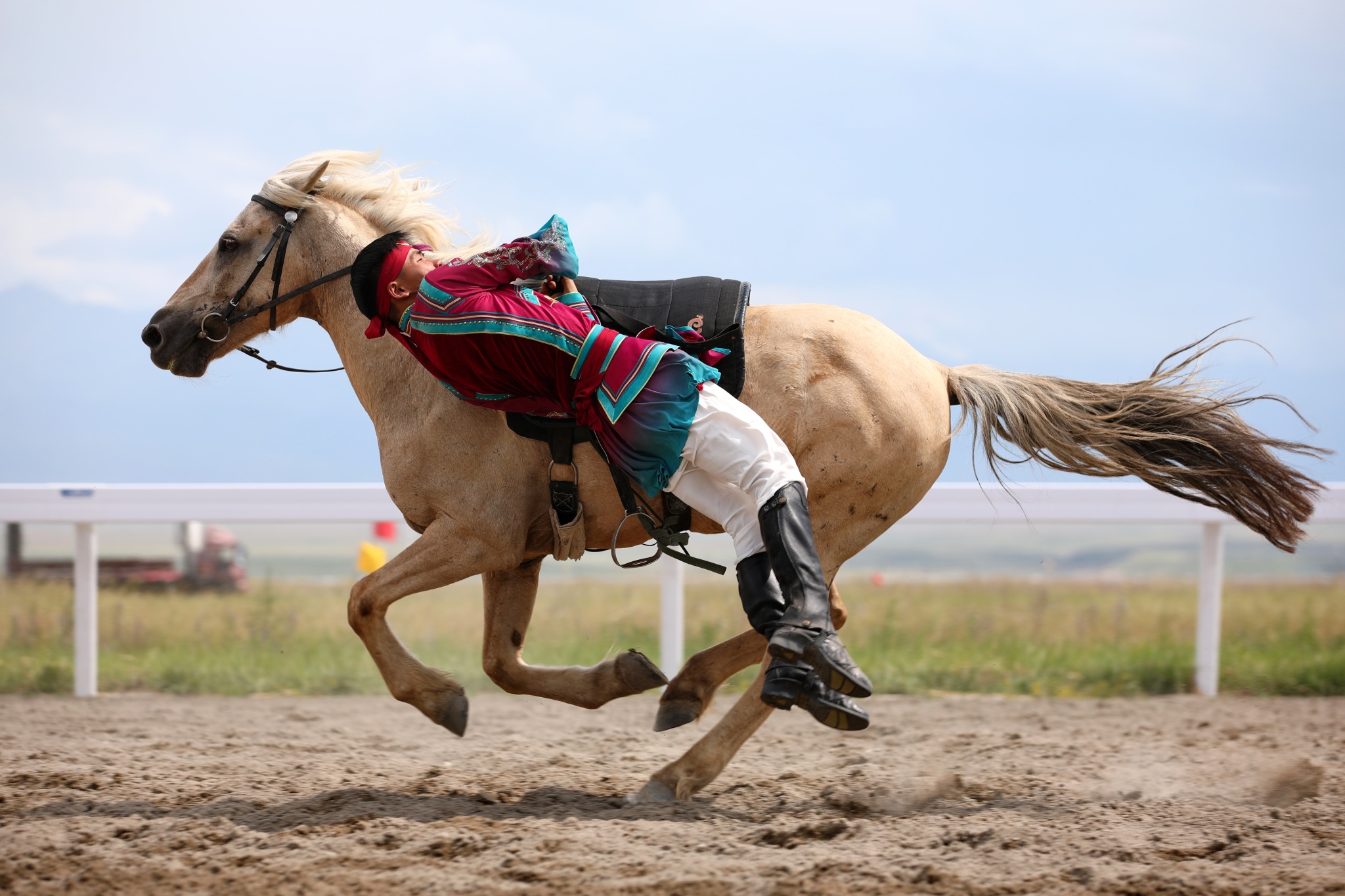 A rider performs stunts on horseback during the equestrian events of China's 12th National Traditional Games of Ethnic Minorities held in Xinjiang on July 8, 2024. /CFP
